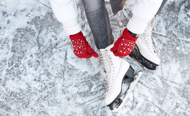 Woman lacing up ice skates