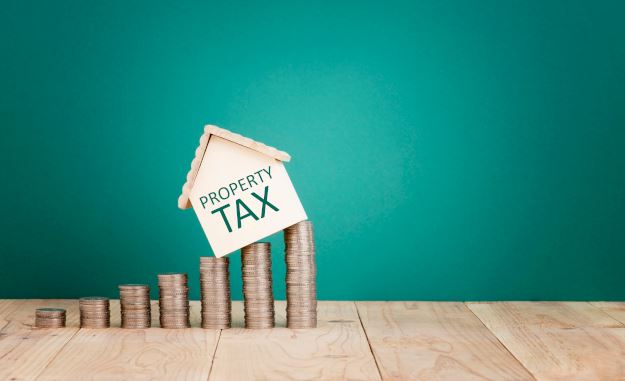 Miniature house on top of stacks of pennies with the word 
